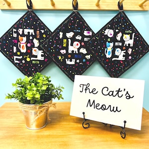 Quilted cat potholder, handmade, black, multicolored cats, 8 x 8, hanging loop
