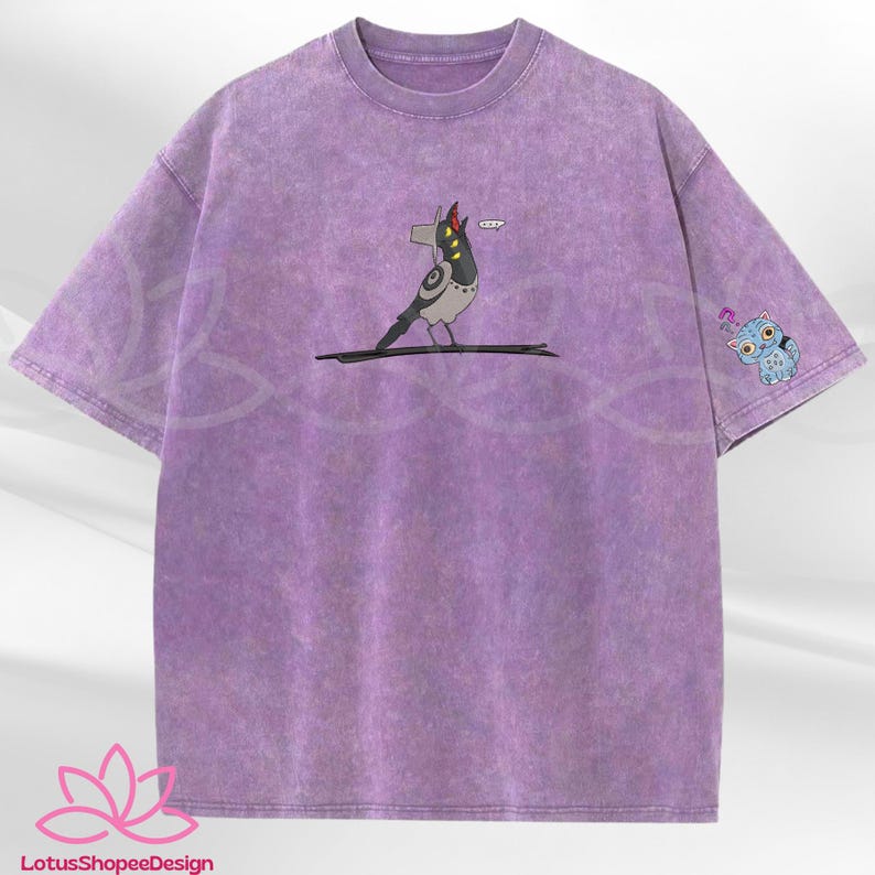 May include: A purple t-shirt with a unique design. The front features a cartoon bird-like character with a red hat. The left sleeve has a small blue owl graphic. The shirt has a textured, washed appearance.