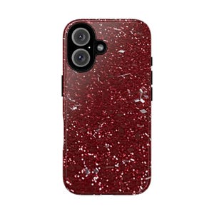 May include: A burgundy phone case with a glittery texture and a dual-lens camera cutout. The case has a glossy finish and a rectangular shape with rounded corners. Silver glitter accents are scattered across the surface.