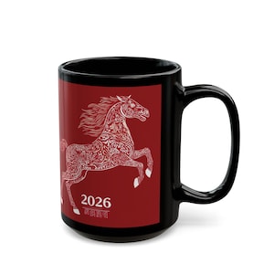 May include: Black ceramic mug featuring a white decorative horse design on a red background. The design includes the year 2026. The mug has a large handle and is suitable for hot or cold beverages.