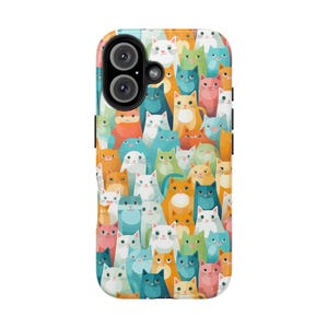 May include: A colorful phone case featuring a repeating pattern of cartoon cats in various colors, including orange, blue, pink, and white. The case has a glossy finish and a camera cutout.