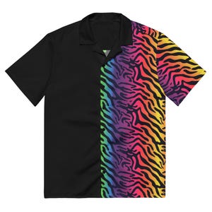 May include: Black short-sleeved shirt with a camp collar. The right side features a vibrant, multicolored zebra stripe pattern in shades of red, orange, yellow, green, blue, and purple. The shirt is a bold statement piece.