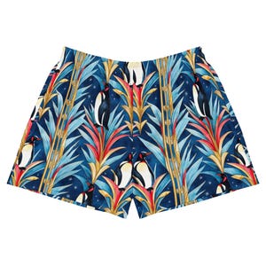 May include: Blue and white patterned shorts with a tropical print featuring penguins and palm trees.