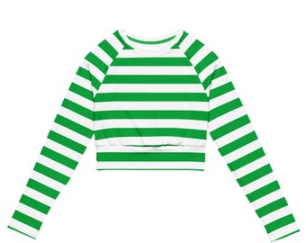 May include: A long-sleeved crop top with horizontal green and white stripes. The top features a crew neck and a fitted, cropped design. The sleeves extend to the wrists, and the stripes are evenly spaced across the fabric.