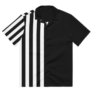 May include: A short-sleeved shirt with a contrasting design. One side has black and white vertical stripes, the other is solid black. The shirt has a classic collar and a relaxed fit, suitable for casual wear. The shirt is made of a lightweight fabric.