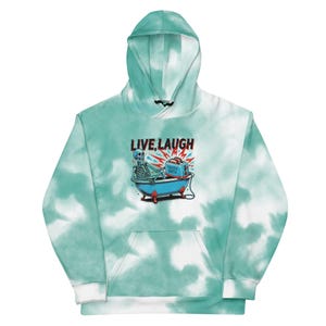 May include: A green and white tie-dye hoodie with a skeleton in a bathtub and the text "LIVE, LAUGH" printed on the front.
