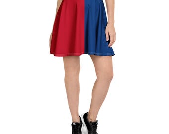 May include: A skater skirt divided vertically into two solid color panels. One panel is red, and the other is blue. The skirt is worn with black sneakers.