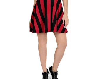 May include: A skater skirt with alternating vertical red and black stripes. The skirt is worn by a person with black sneakers. The skirt's design is bold and eye-catching, suitable for casual wear.