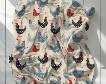 May include: A soft throw blanket featuring a repeating pattern of chickens in black, light blue, and red against a cream background. The chickens are decorated with white polka dots and have red combs and wattles, interspersed with small red dots.