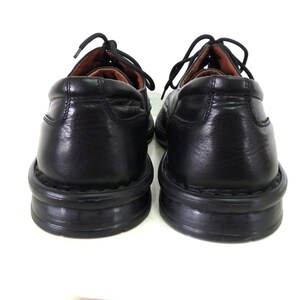 May include: A pair of black leather lace-up shoes with a rubber sole. The shoes have a classic design and are in good condition.