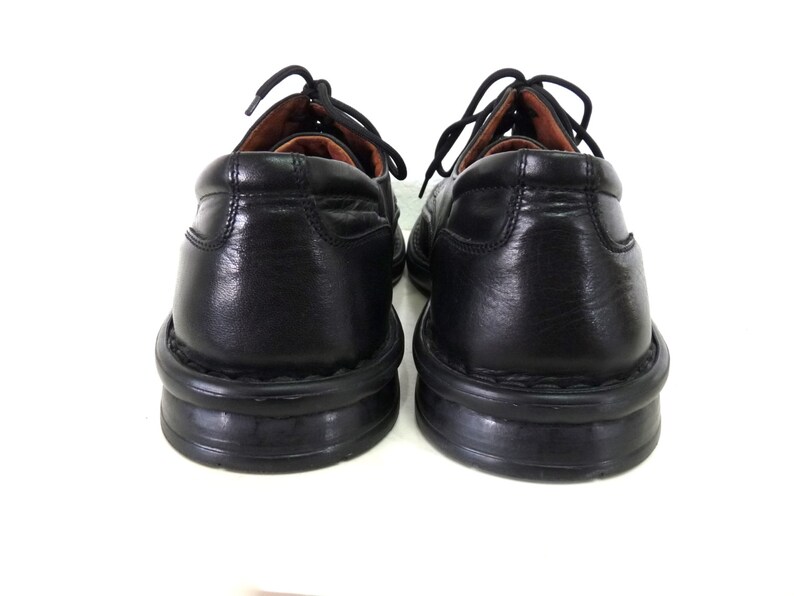 May include: A pair of black leather lace-up shoes with a rubber sole. The shoes have a classic design and are in good condition.