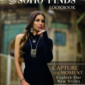 The image is a cover for a SOHO FINDS LOOKBOOK featuring a woman in a black dress posing in front of a building.