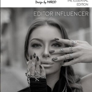 The image is a black and white photo of a woman with long hair wearing multiple rings on her fingers. She is holding her hand up to her face, obscuring her face. The image appears to be a collage of multiple images, and the text includes "SOHO FINDS", "URBAN COUTURE COLLECTION", "THE ESSENTIAL EDITION", "EDITOR INFLUENCER", "NEXT LEVEL", and "VOL2".