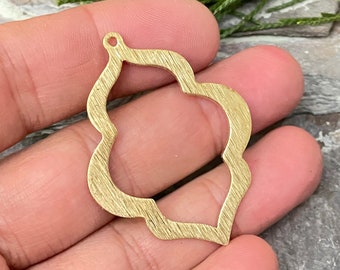 May include: Gold metal ornament with a decorative, openwork design. The ornament has a textured surface and a hole at the top for hanging.