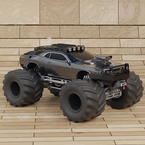 May include: A gray monster truck with large black tires, a roof rack, and four spotlights. The vehicle has a black hood scoop and a front bumper. The truck is parked on a wooden surface.