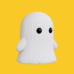 May include: A white ghost-shaped figurine with a knitted texture. The ghost has two large, black, round eyes and small, rounded arms. The background is a solid yellow.