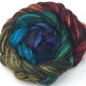 May include: A ball of colorful yarn with shades of red, orange, yellow, green, blue, purple, and black. The yarn is arranged in a spiral pattern.