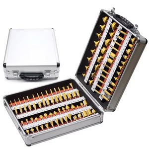 May include: A set of 80 router bits in a silver aluminum case. The bits are organized in rows and columns and are labeled with numbers. The case has a handle and a latch.