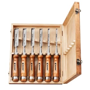 May include: Set of six wood carving chisels with wooden handles, in a wooden box with a hinged lid. The chisels are labelled "K&ZARC" and have different sizes.