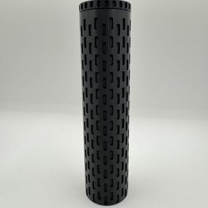 May include: A black cylindrical smoker tube with a grid pattern of holes. The tube is about 10 inches long and 2 inches in diameter.