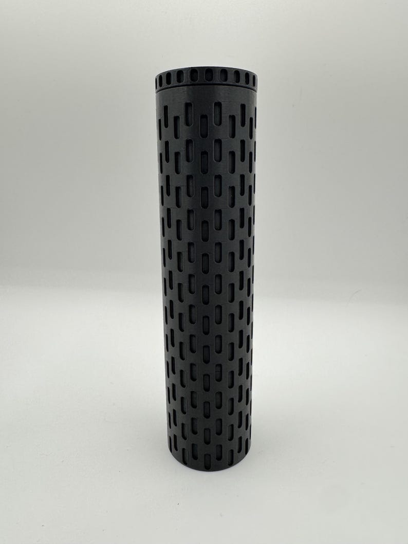 May include: A black cylindrical smoker tube with a grid pattern of holes. The tube is about 10 inches long and 2 inches in diameter.