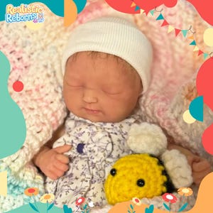 Full body silicone infant, dressed as a newborn