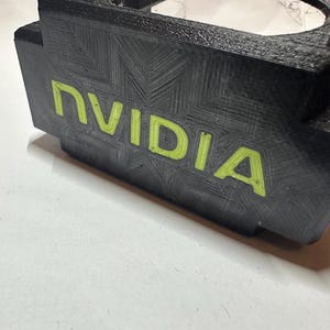 May include: Black plastic case with a circular opening and the word "NVIDIA" printed in green.