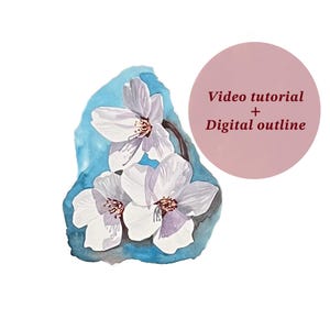 May include: Watercolour painting of white flowers with yellow centres, set against a blue background. A pink circle with the text "Video tutorial + Digital outline" is in the upper right corner. The artwork is on a white background.