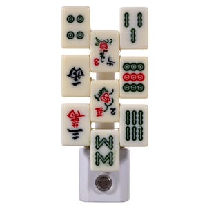 May include: A white night light featuring a vertical arrangement of Mahjong tiles. The tiles display various symbols and numbers in green and red, with a white base and a small on/off switch.