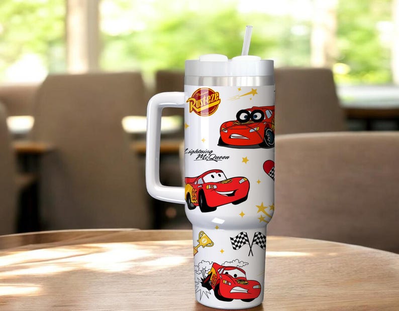 May include: A white tumbler with a handle, featuring illustrations of the character Lightning McQueen from the movie Cars. The tumbler has a white lid with a straw and the text "Rusteze" and "Lightning McQueen".