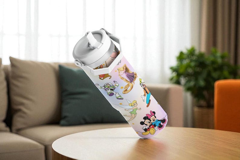 May include: A white and grey water bottle with a handle, decorated with cartoon characters. The bottle is on a wooden table in a room. The characters include Mickey and Minnie Mouse, Buzz Lightyear, and others. The bottle is likely to hold around 750ml.
