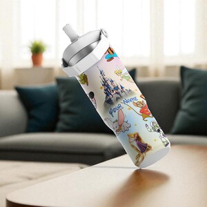 May include: A white and silver water bottle with a colourful design featuring cartoon characters and a castle. The text "Your Name" is visible. The bottle has a white lid and a handle.