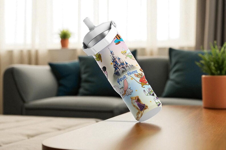 May include: A white and silver water bottle with a colourful design featuring cartoon characters and a castle. The text "Your Name" is visible. The bottle has a white lid and a handle.