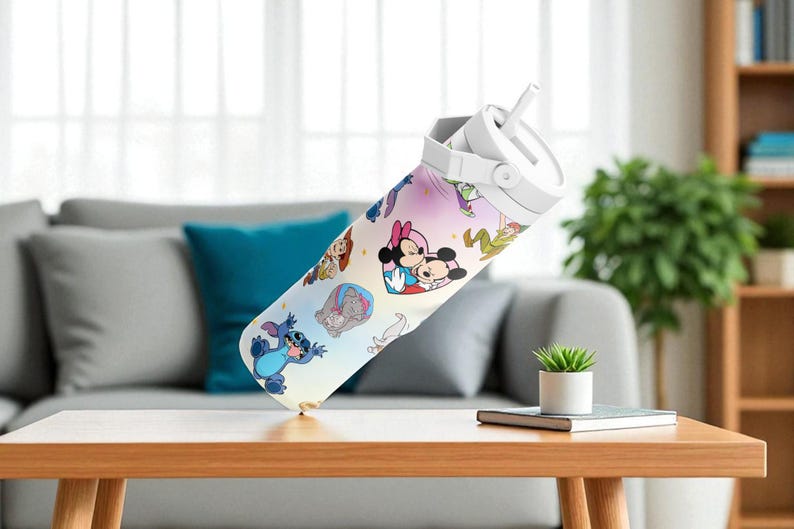 May include: A white water bottle with a cartoon design featuring Mickey and Minnie Mouse, Stitch, and other characters. The bottle has a white lid with a straw and is set on a wooden table. The background includes a grey sofa and a green plant.