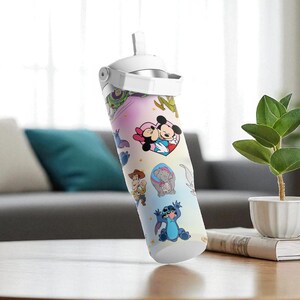 May include: A water bottle with a white lid and straw, decorated with Disney characters including Mickey and Minnie Mouse, and Stitch. The bottle is set against a background with a sofa, cushions, and a small plant.