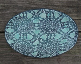 Light green oval pottery platter with lace texture