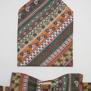 May include: A brown, orange, and green patterned bow tie and matching pocket square. The pattern features geometric shapes and leaves.