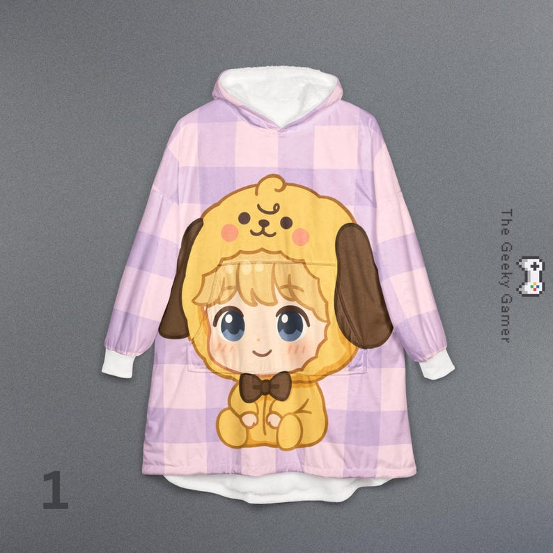 May include: A hooded blanket featuring a cartoon character in a yellow dog costume with brown ears and a bow tie. The blanket has a pink and purple plaid pattern and white lining. The text "The Geeky Gamer" is visible.