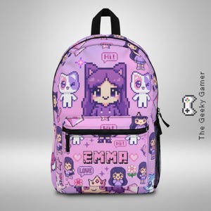 May include: A light purple backpack with a pixelated design featuring a girl, cats, and the name "EMMA". The backpack has a black handle and zipper, and the design includes the word "LOVE" and "Hi!".
