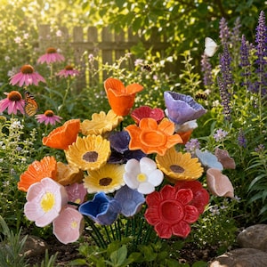 May include: A collection of colorful ceramic flowers on thin green stems, featuring various shapes and sizes in shades of orange, yellow, red, blue, purple, pink, and white, arranged together to form a vibrant, multi-colored floral display.