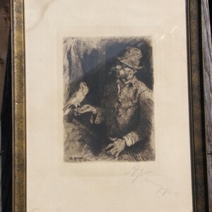 May include: A black and white etching of a man wearing a hat and holding a bird. The etching is signed "A. Van Muyden" in the bottom right corner.
