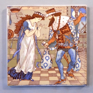 May include: Square ceramic tile with a historical illustration of King Arthur and a woman. The artwork shows the king in a crown and ornate clothing, holding bags, with the text "Ye Good King Arthur" at the top. The woman is in a white dress.