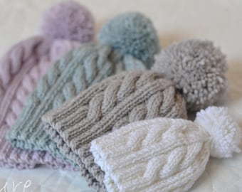 Cabled pom pom hat knitting pattern Oscar newborn to adult