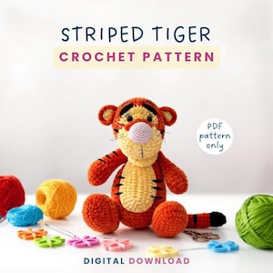 May include: A crocheted tiger toy with orange and yellow stripes, black accents, and a pink nose. The image includes text that reads "Striped Tiger Crochet Pattern" and "Digital Download."