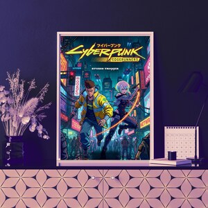 May include: A framed art print featuring Cyberpunk: Edgerunners. The image shows two characters in a futuristic city with neon lights. The male character is in a yellow jacket, and the female character holds a weapon. The print includes the text "Cyberpunk" and "Edgerunners".