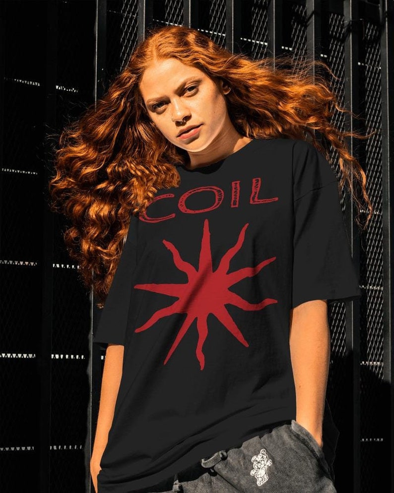 May include: A black t-shirt with a red starburst design and the word "COIL" in red lettering.