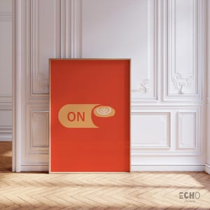 May include: A red poster with a yellow switch that says "ON" and a coffee cup with latte art on top of the switch.
