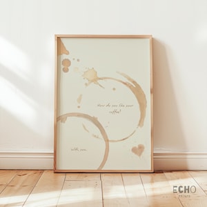 Puede incluir: Una impresión enmarcada con un fondo marrón claro que presenta manchas de café y el texto "¿Cómo te gusta tu café? Contigo."