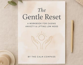 May include: A workbook titled "The Gentle Reset" with text that reads "A Workbook for Easing Anxiety & Lifting Low Mood" and "By The Calm Compass." The cover features a sun design above open hands. A pen and a candle are also visible.