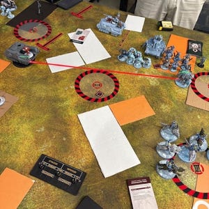 May include: A white ceramic mug with a black handle and the text "But First, Coffee" in a black, handwritten-style font. The mug is on a white surface.